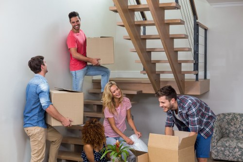 Removal van and moving crew preparing for a house move
