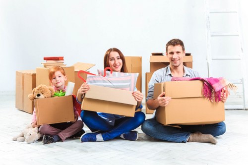 Careful packing of fragile household items during a Brixton move