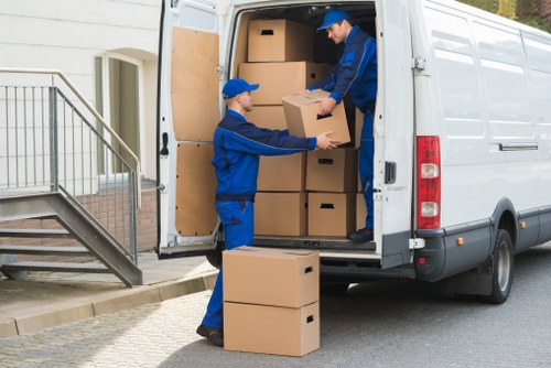 Man with van loading moving boxes in Brixton street