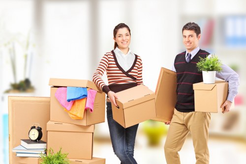 Movers carrying furniture through a Brixton property