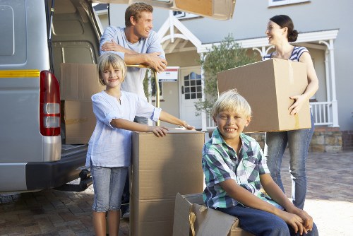 Professional movers handling fragile items carefully during a Brixton removal