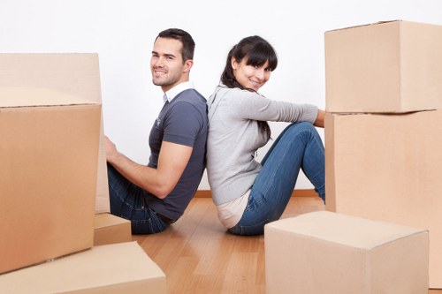 Movers using safe lifting techniques with equipment support